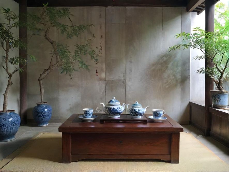 一间温馨私密的茶室，柔和的灯光下，舒适的沙发和一杯香茗，营造出宁静放松的氛围